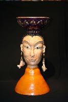Ceramic sculpture of Karma with gold lefed bowl on head inspired bu buddha 