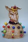 ceramic sculpture of Juggler King dog with multi colored rainbow balls over its body